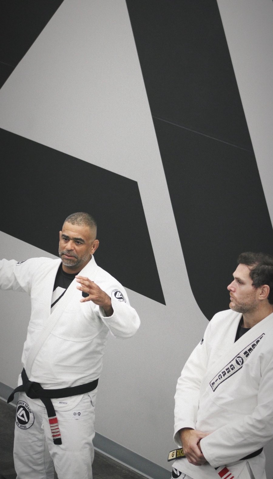 Professor Alex Faria, left, with Professor Roger Gracie, right, at Roger Gracie Academy Frisco