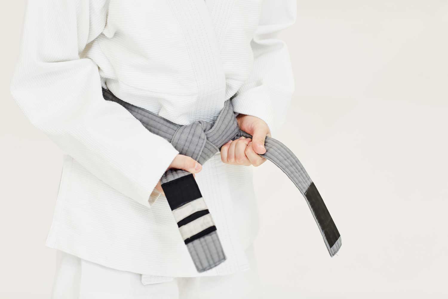 Child earning a grey belt promotion